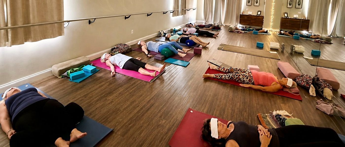 Students resting on mats during a yoga class at Platinum