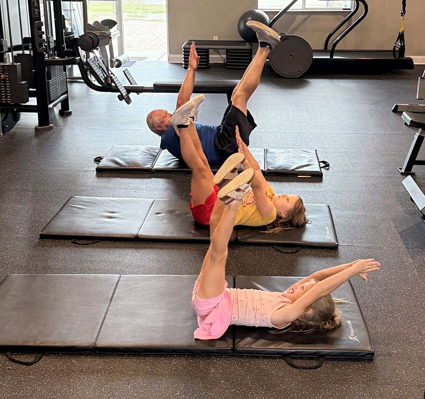 Clients working on mobility on mats in the Platinum studio